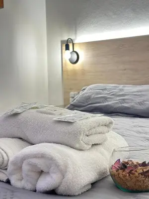 a pile of towels sitting on top of a bed at Chrome Hotel in Río Cuarto