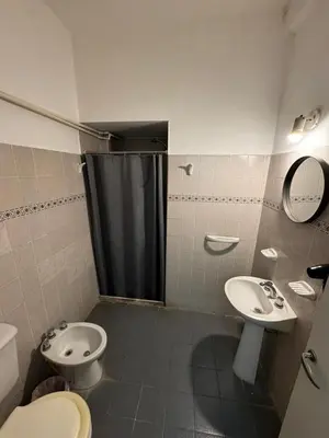 a bathroom with a toilet and a sink and a shower at Chrome Hotel in Río Cuarto