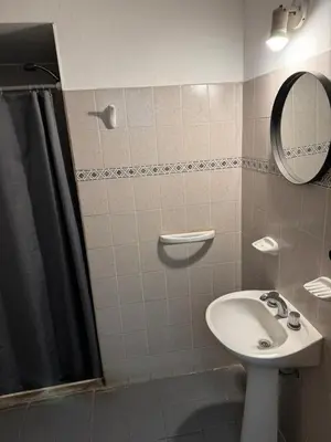 a bathroom with a sink and a shower with a mirror at Chrome Hotel in Río Cuarto
