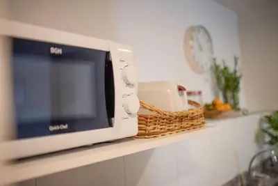 a microwave sitting on a counter in a kitchen at Coral State Premium Tower in Cordoba