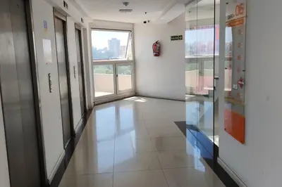 an empty hallway in a building with a window at Coral State Premium Tower in Cordoba