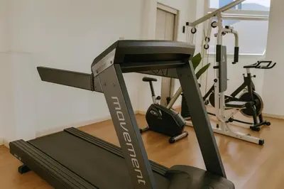 a gym with a treadmill and two exercise bikes at Coral State Premium Tower in Cordoba