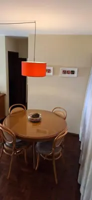 a dining room table with chairs and a lamp at cordoba departamentos por dia cañada in Cordoba