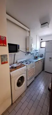 a kitchen with a washer and a washing machine at cordoba departamentos por dia cañada in Cordoba