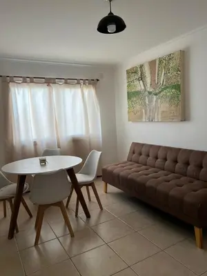 a living room with a couch and a table at Tejas in Cordoba