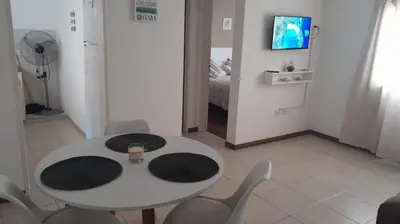 a room with a table and chairs and a television at Tejas in Cordoba
