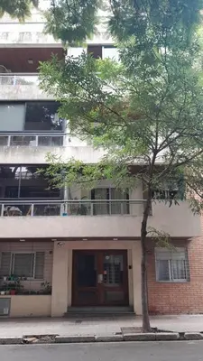 a building with a tree in front of it at Tejas in Cordoba