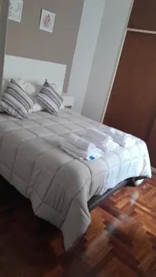 a large bed in a bedroom with a wooden floor at Tejas in Cordoba