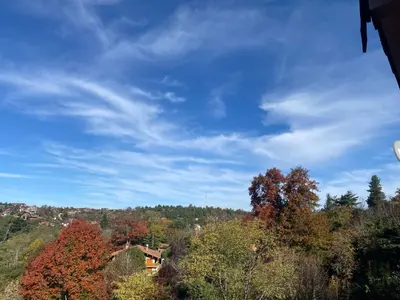 a view of a hill with trees and a blue sky at Casa Raíz Cumbrecita in La Cumbrecita