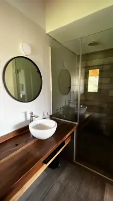 a bathroom with a sink and a large mirror at Casa Raíz Cumbrecita in La Cumbrecita