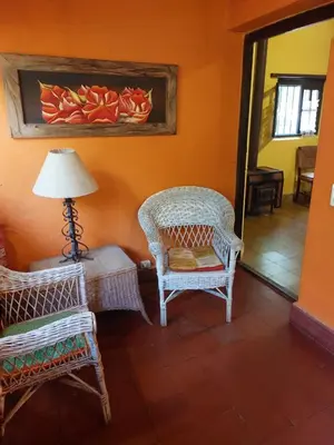 a room with two wicker chairs and a table and a lamp at Cabañas spa el petrel in San Javier
