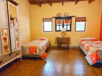 a room with two beds and a table in it at Cabañas spa el petrel in San Javier