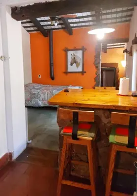 a room with a table and two chairs and a bed at Cabañas spa el petrel in San Javier