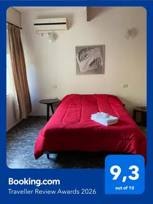 a bedroom with a red bed in a room at La Casita Yogui in Santa Rosa de Calamuchita
