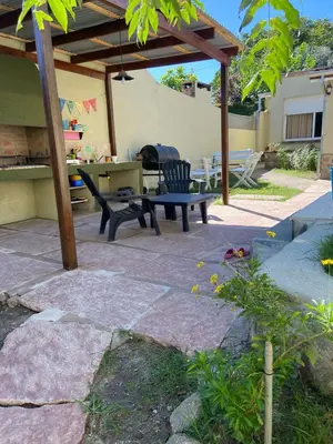 a patio with a picnic table and a bench at La Casita Yogui in Santa Rosa de Calamuchita