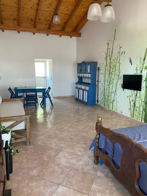 a living room with a bed and a ping pong table at La Casita Yogui - MONOAMBIENTE 2 in Santa Rosa de Calamuchita