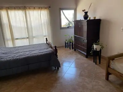 a bedroom with a bed and a dresser at La Casita Yogui - MONOAMBIENTE 2 in Santa Rosa de Calamuchita