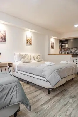 a bedroom with two beds and a desk at Departamento 3 Paris - Edificio VILAUT by INMOVE Temporarios in Cordoba