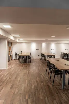 an empty room with wooden tables and chairs at Departamento 3 Paris - Edificio VILAUT by INMOVE Temporarios in Cordoba