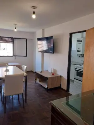 a living room with a table and a tv on the wall at Nueva Córdoba Argentina externo luminoso in Cordoba