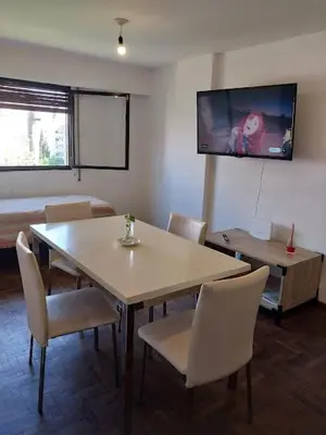 a dining room with a table and chairs and a tv at Nueva Córdoba Argentina externo luminoso in Cordoba