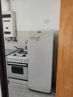 a kitchen with a white refrigerator and a stove at Nueva Córdoba Argentina externo luminoso in Cordoba