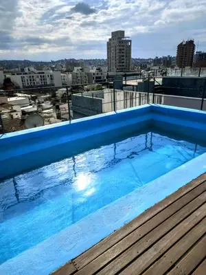 a swimming pool on the roof of a building at Oasis depto en centro carlos paz in Villa Carlos Paz