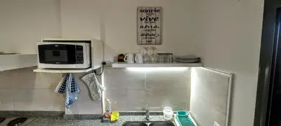a kitchen with a sink and a microwave at Oasis depto en centro carlos paz in Villa Carlos Paz