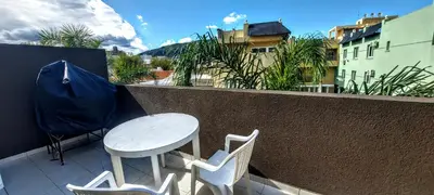 a white table and two chairs on a balcony at Oasis depto en centro carlos paz in Villa Carlos Paz