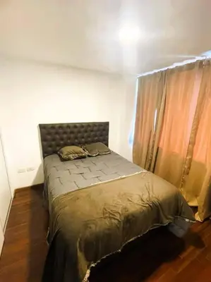 a bedroom with a bed in a room with a window at Elegante en B° General Paz in Cordoba