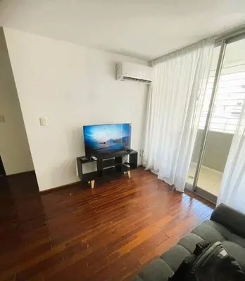 a living room with a couch and a flat screen tv at Elegante en B° General Paz in Cordoba