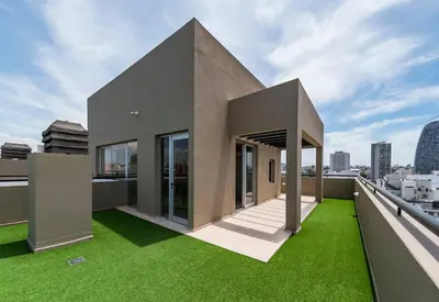 a building with green grass on a roof at Elegante en B° General Paz in Cordoba