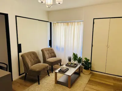 a living room with two chairs and a coffee table at Departamento confortable centro Wi Fi - cochera opcional in Cordoba