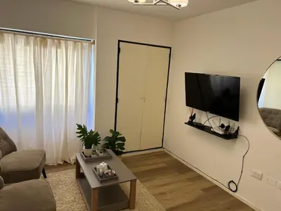 a living room with a flat screen tv on a wall at Departamento confortable centro Wi Fi - cochera opcional in Cordoba