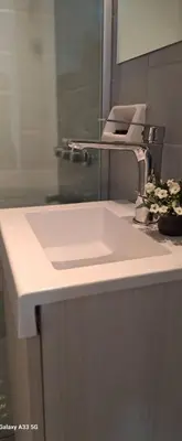 a bathroom counter with a sink and a mirror at AL TOQUE DEL OLMOS Luminoso y confortable in Cordoba