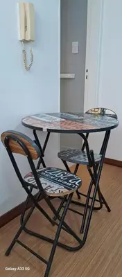 a table and two chairs under a table and a phone at AL TOQUE DEL OLMOS Luminoso y confortable in Cordoba
