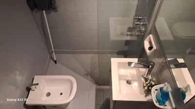 a white bathroom with a sink and a toilet at AL TOQUE DEL OLMOS Luminoso y confortable in Cordoba