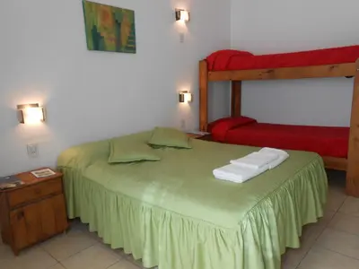 a bedroom with a bed and a bunk bed at Alta Gracia Hostel in Alta Gracia
