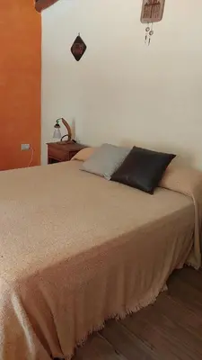 a bed with two pillows on it in a bedroom at Cabañas walcarpi in Villa Ciudad Parque
