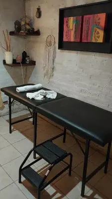 a black table and a chair in a room at Cabañas walcarpi in Villa Ciudad Parque
