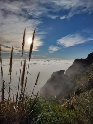 a view of a foggy valley with the sun above the clouds at Cabañas La Victoria, Las Calles, Traslasierras, Córdoba in Las Rabonas