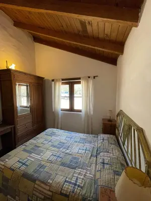 a bedroom with a bed and a window at Cabañas La Victoria, Las Calles, Traslasierras, Córdoba in Las Rabonas