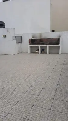 a white bench in a room with a tile floor at Bedoya in Cordoba
