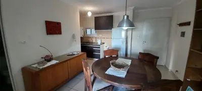 a kitchen with a wooden table and a dining room at Bedoya in Cordoba