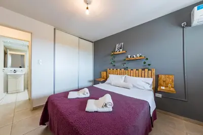 a bedroom with a large bed with towels on it at ALTOS DE COLON in Cordoba