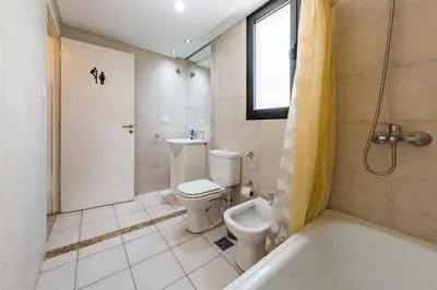 a bathroom with a toilet and a shower and a tub at ALTOS DE COLON in Cordoba