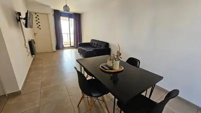 a living room with a black table and chairs at ALTOS DE COLON in Cordoba