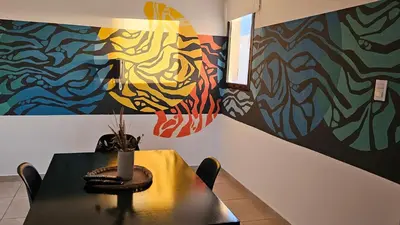 a table with a vase on it in front of a painting at ALTOS DE COLON in Cordoba