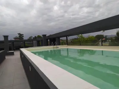 a swimming pool on the roof of a building at Zona residencial frente al lago! in Villa Carlos Paz