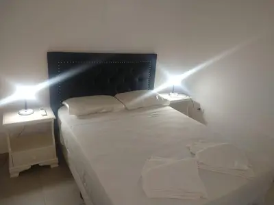 a bedroom with a bed with two lights on it at Zona residencial frente al lago! in Villa Carlos Paz